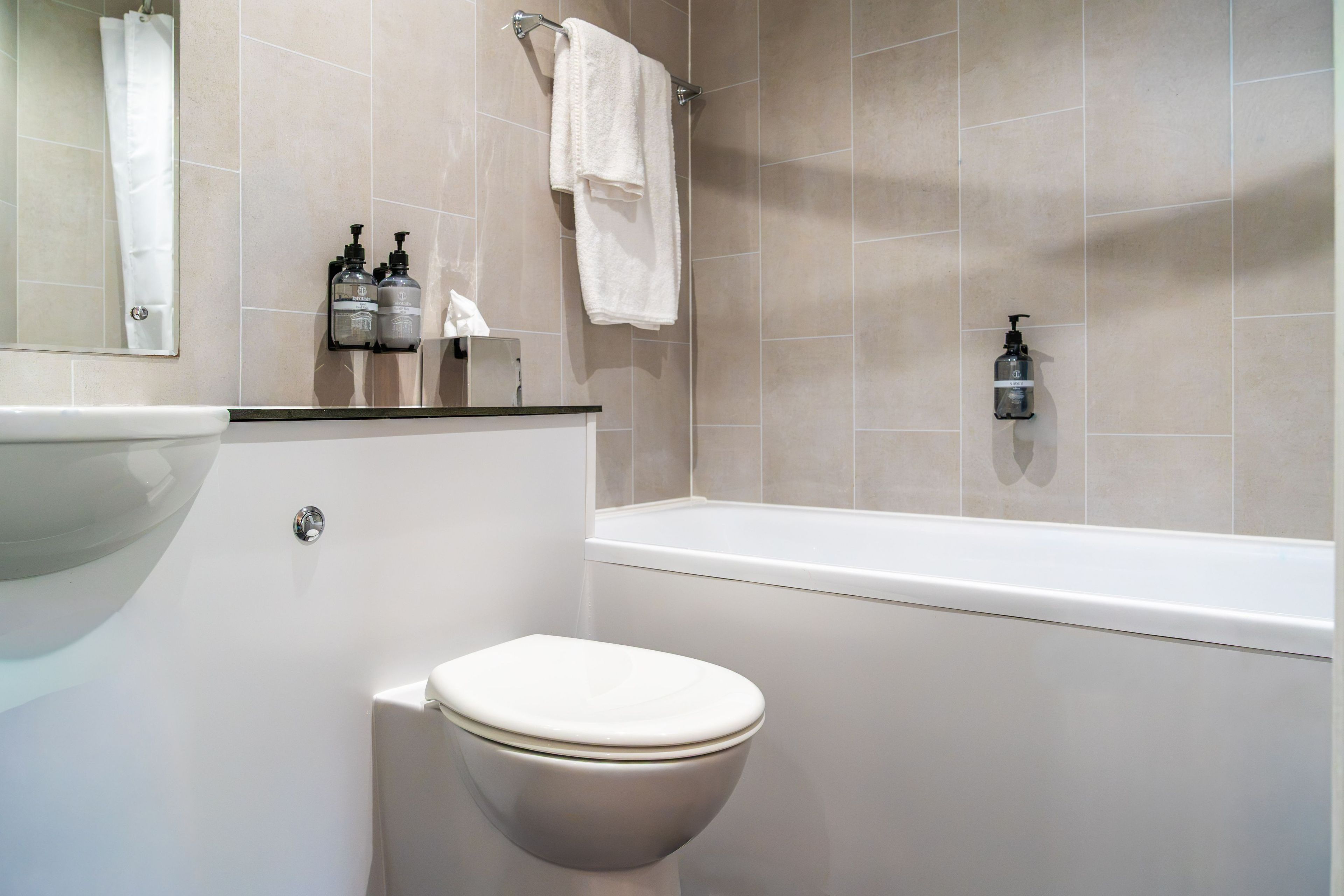 A bathroom with a toilet, a sink, and a bathtub.