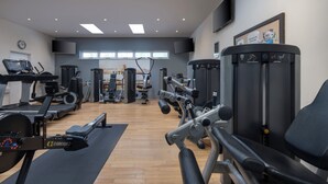A spacious gym with various exercise equipment, including treadmills, weight machines, and a rowing machine. - Delta Hotels by Marriott Northampton (Northampton)