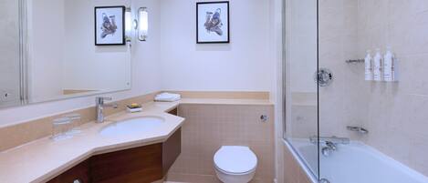 A modern bathroom with a large mirror, a sink, a toilet, and a shower area.