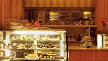 A bakery display case with various cakes and pastries.