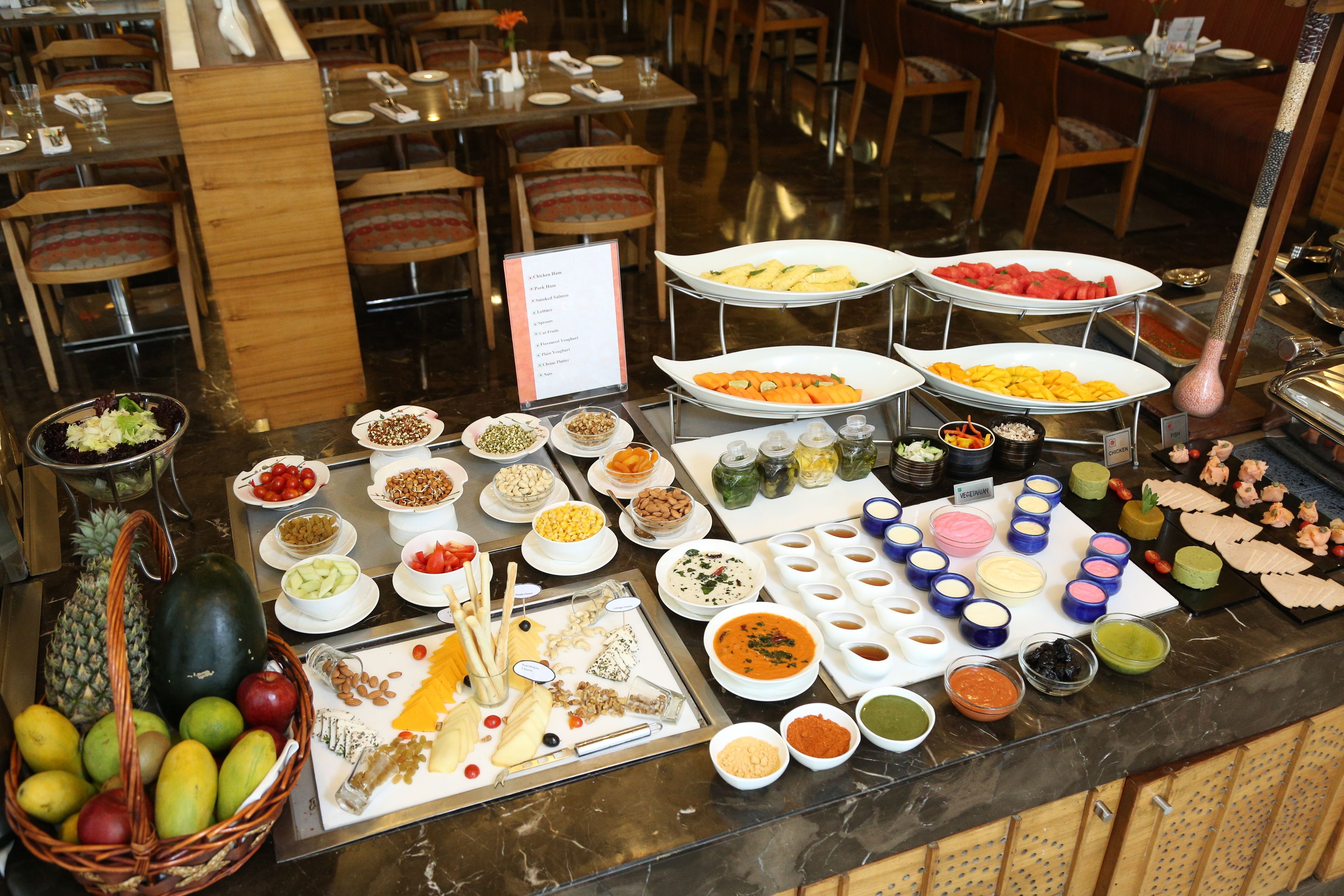 A buffet with various food items and condiments.