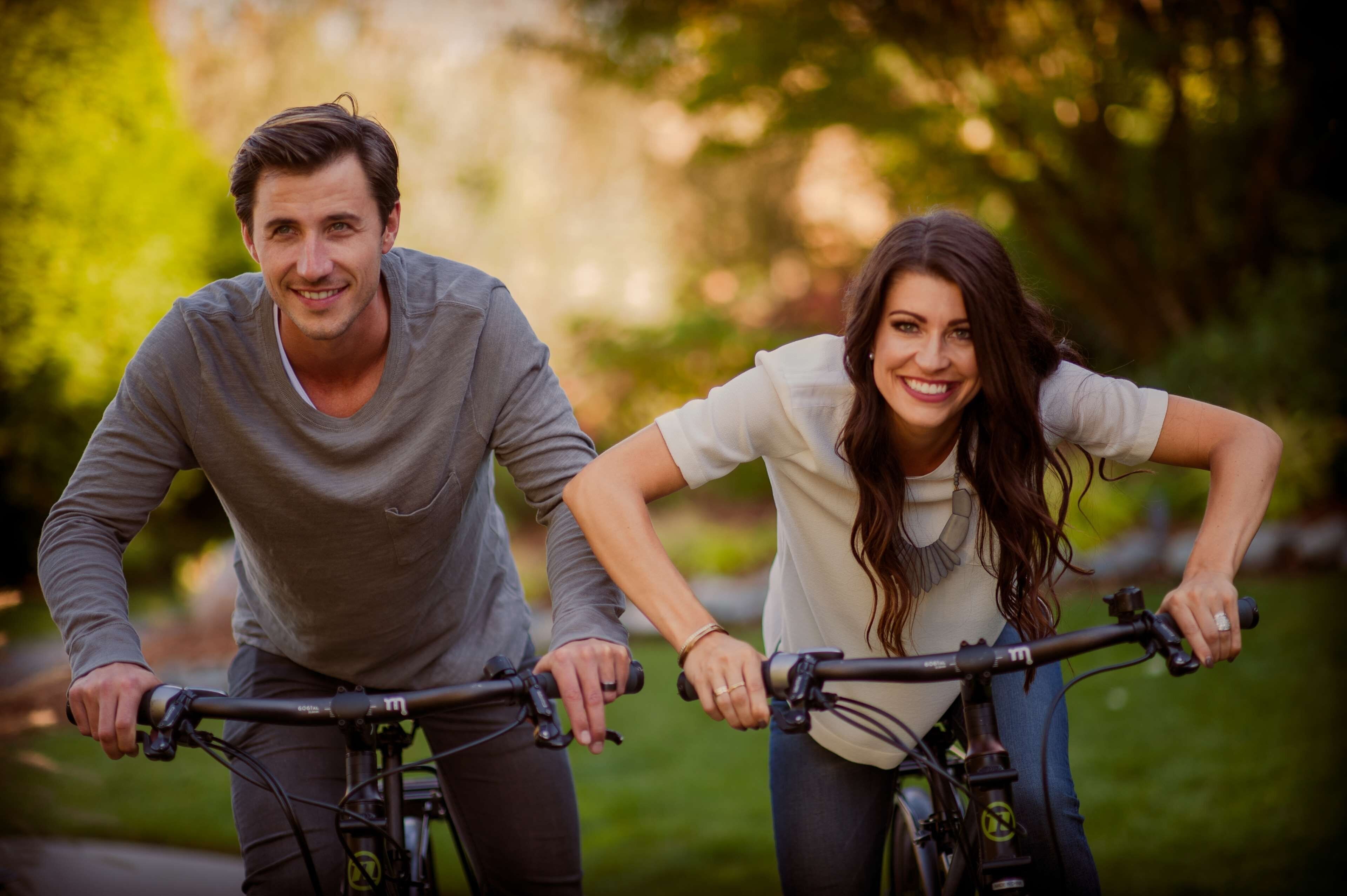 Two people on bicycles in an outdoor setting.