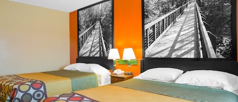 A hotel room with two beds, a nightstand with lamps, and a large framed picture of a bridge.