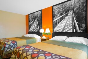 A hotel room with two beds, a nightstand with lamps, and a large framed picture of a bridge. - Americas Best Value Inn Talladega (Talladega)