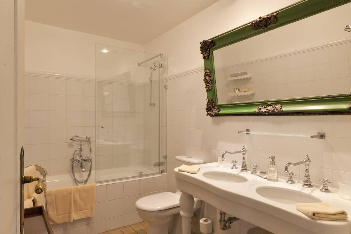 luxury suite | bathroom | bathtub, designer toiletries, hair dryer, bathrobes
