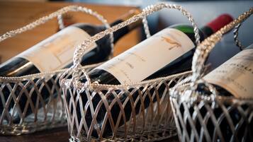 Three wine bottles in a decorative metal basket.