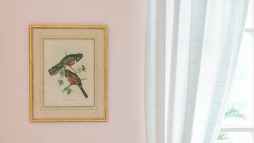 A framed bird illustration on a wall.