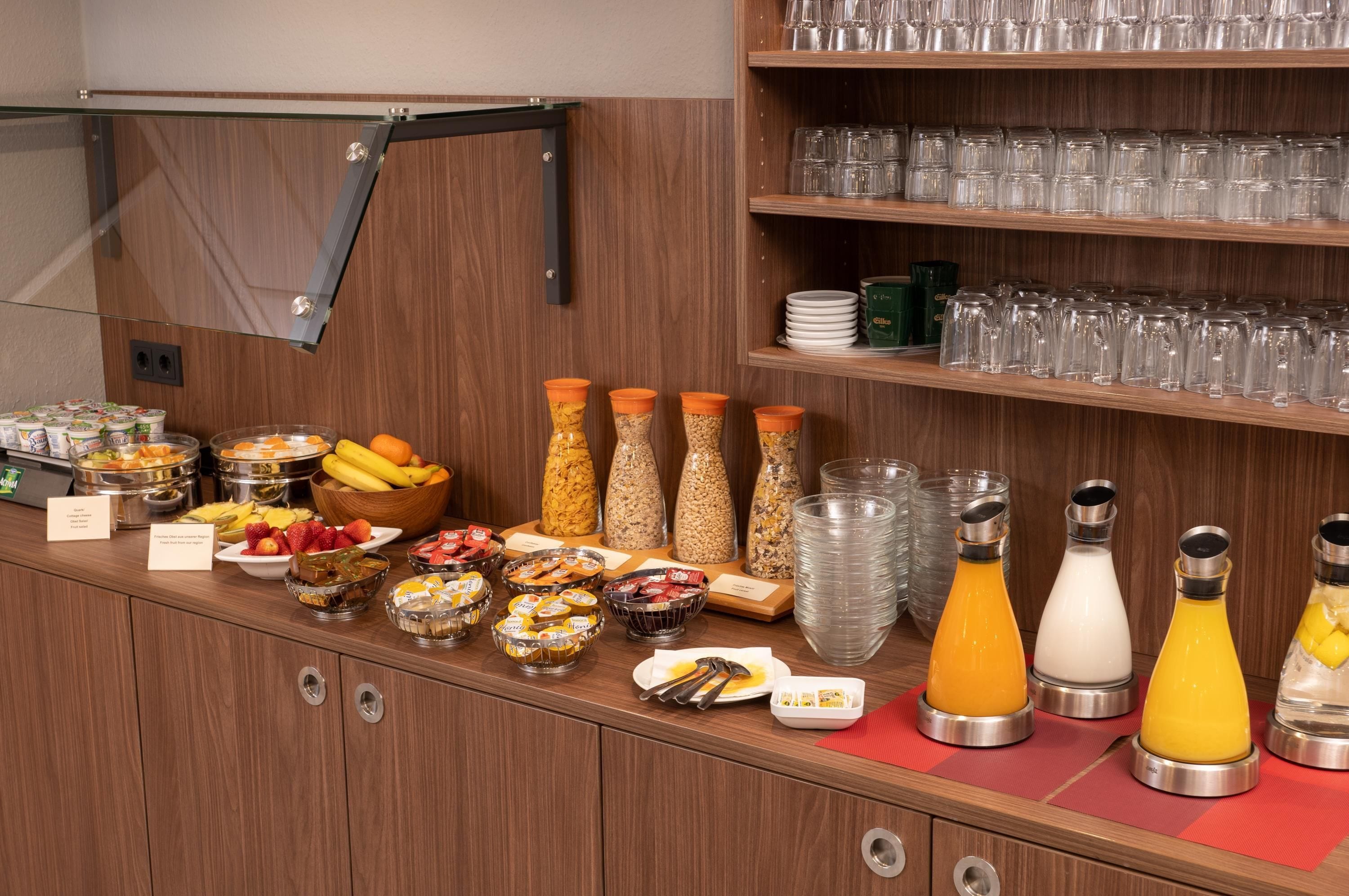 A buffet setup with various food items and beverages.
