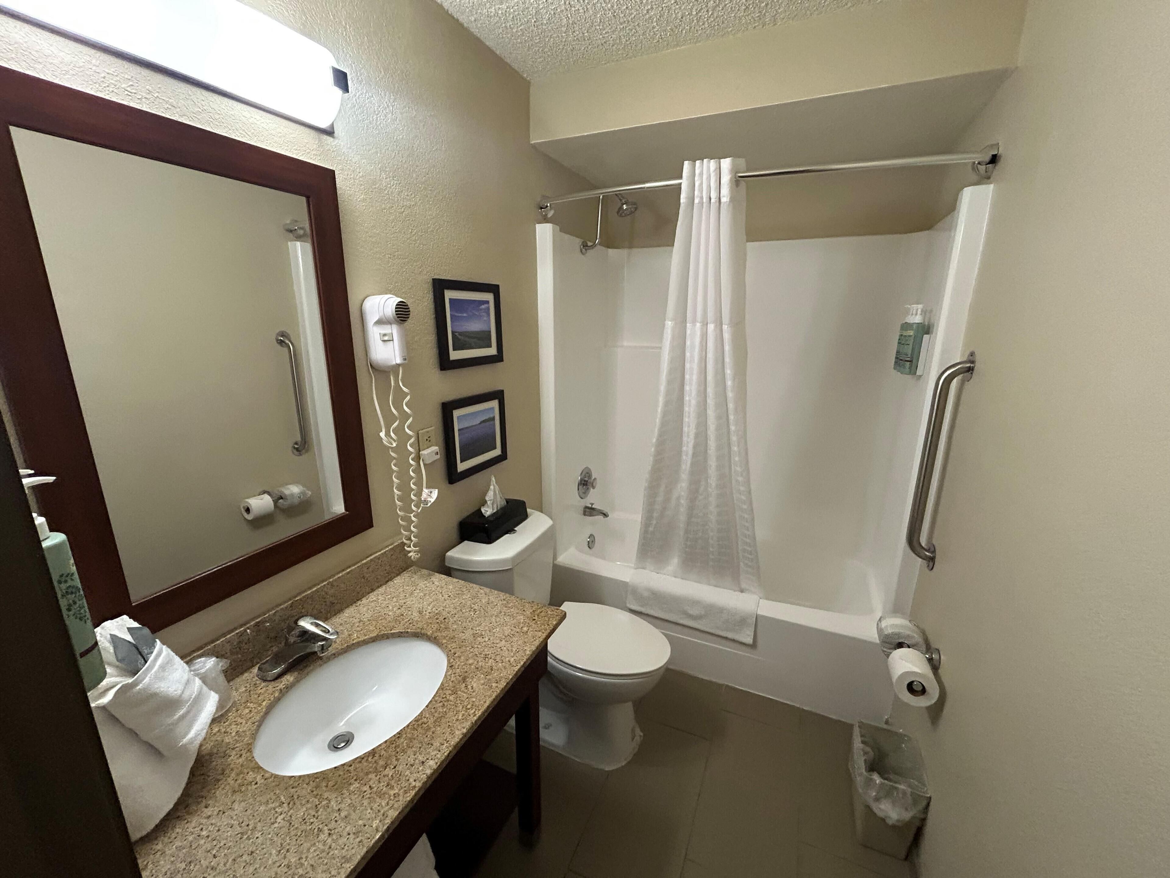 A bathroom with a sink, toilet, and bathtub.