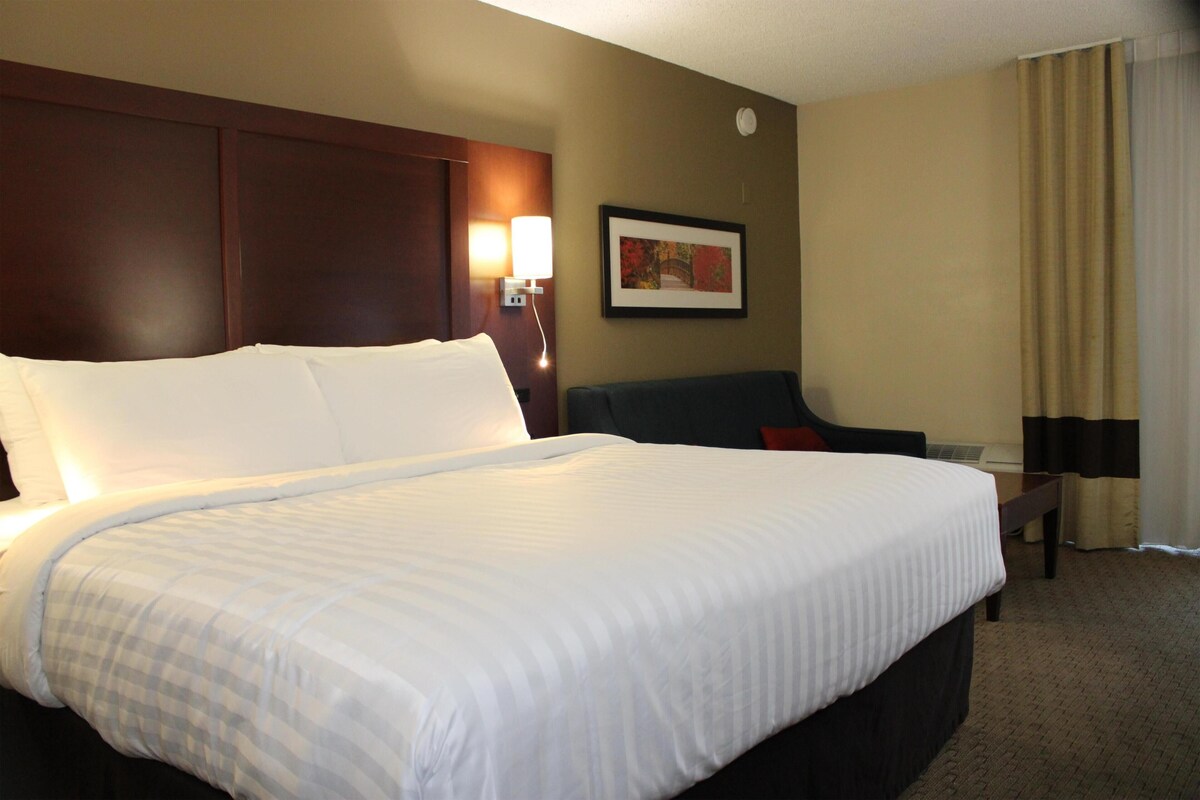 Premium bedding, desk, laptop workspace, blackout drapes