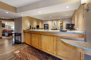 A hotel reception area with a counter, seating, and a reception desk. - Best Western Rochelle Inn & Suites near DeKalb (Rochelle)