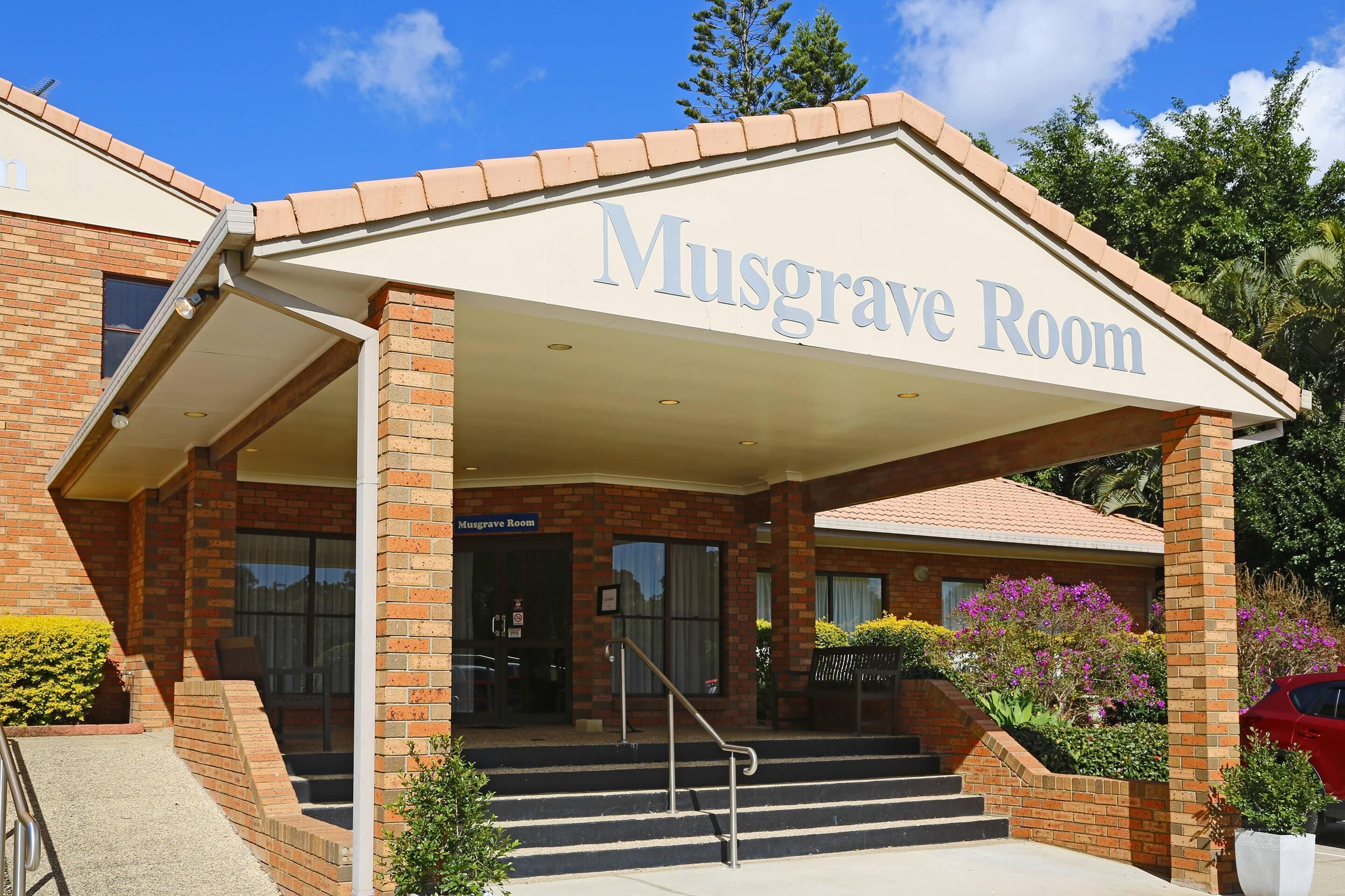 A building with a sign reading 'Musgrave Room' and a set of stairs leading to the entrance.