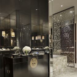 Bathroom features a sleek vanity with a large mirror and marble countertop.