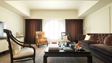 A modern living room with a sofa, armchair, and coffee table.