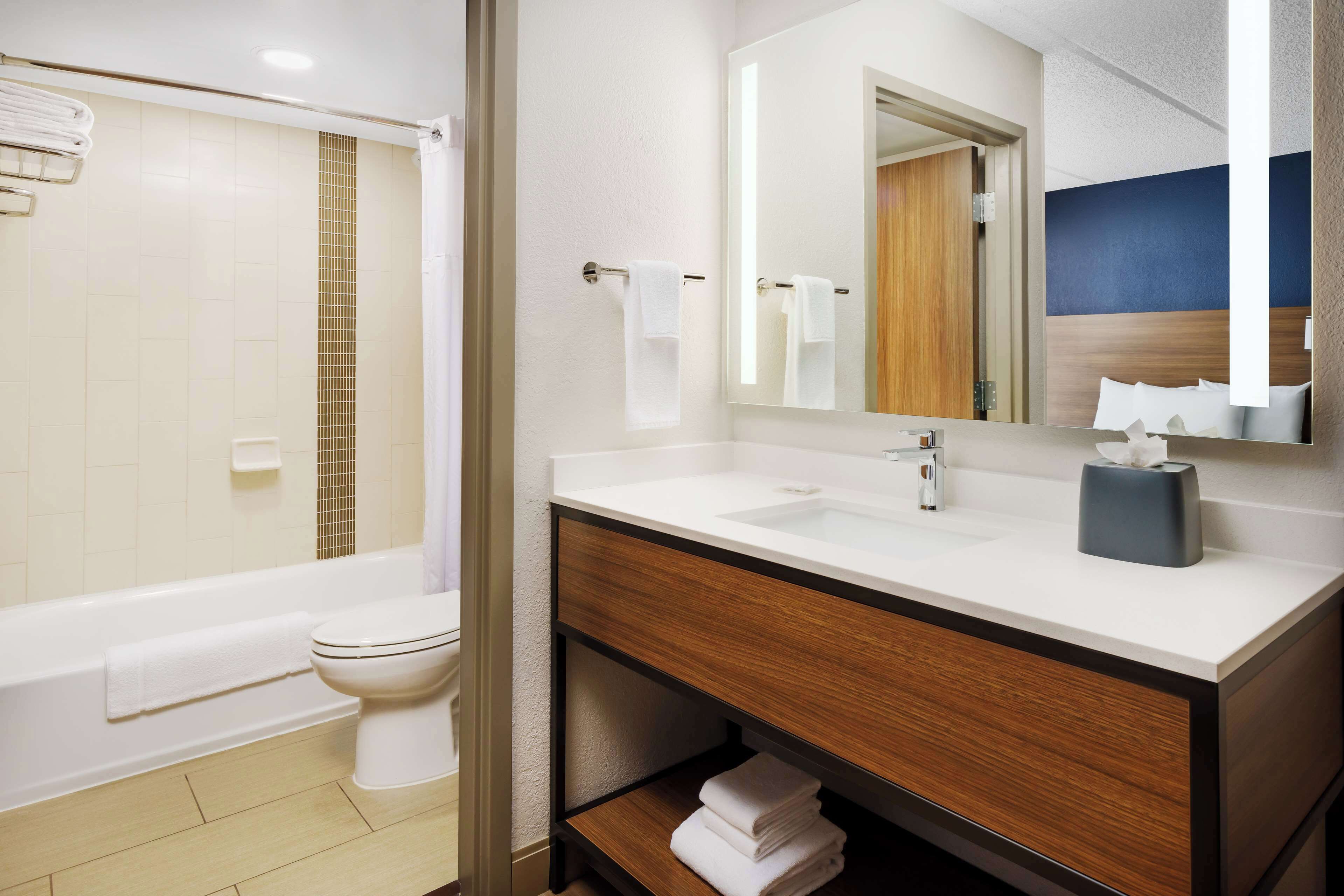 designer toiletries, hair dryer, towels