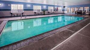 An indoor swimming pool with clear water, surrounded by blue-tiled walls and multiple windows. - La Quinta Inn & Suites by Wyndham Eugene (Eugene)