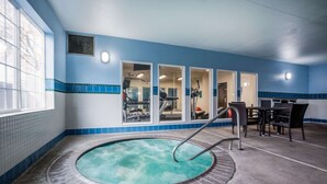 A pool area with a hot tub, exercise equipment, and a seating area with chairs and tables. - La Quinta Inn & Suites by Wyndham Eugene (Eugene)