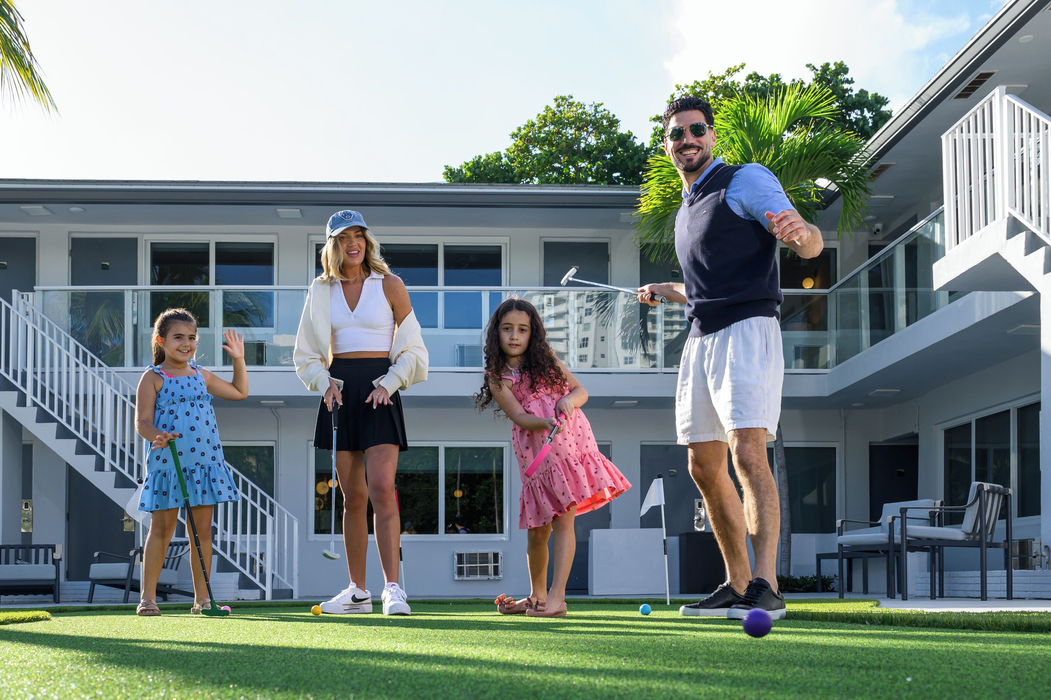 A modern building with a multi-level design, outdoor seating, and a well-maintained lawn.