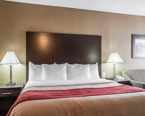 Relax in comfort with a large bed, two bedside tables, and a cozy chair.