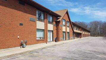 A row of brick buildings with large windows and a flat roof.