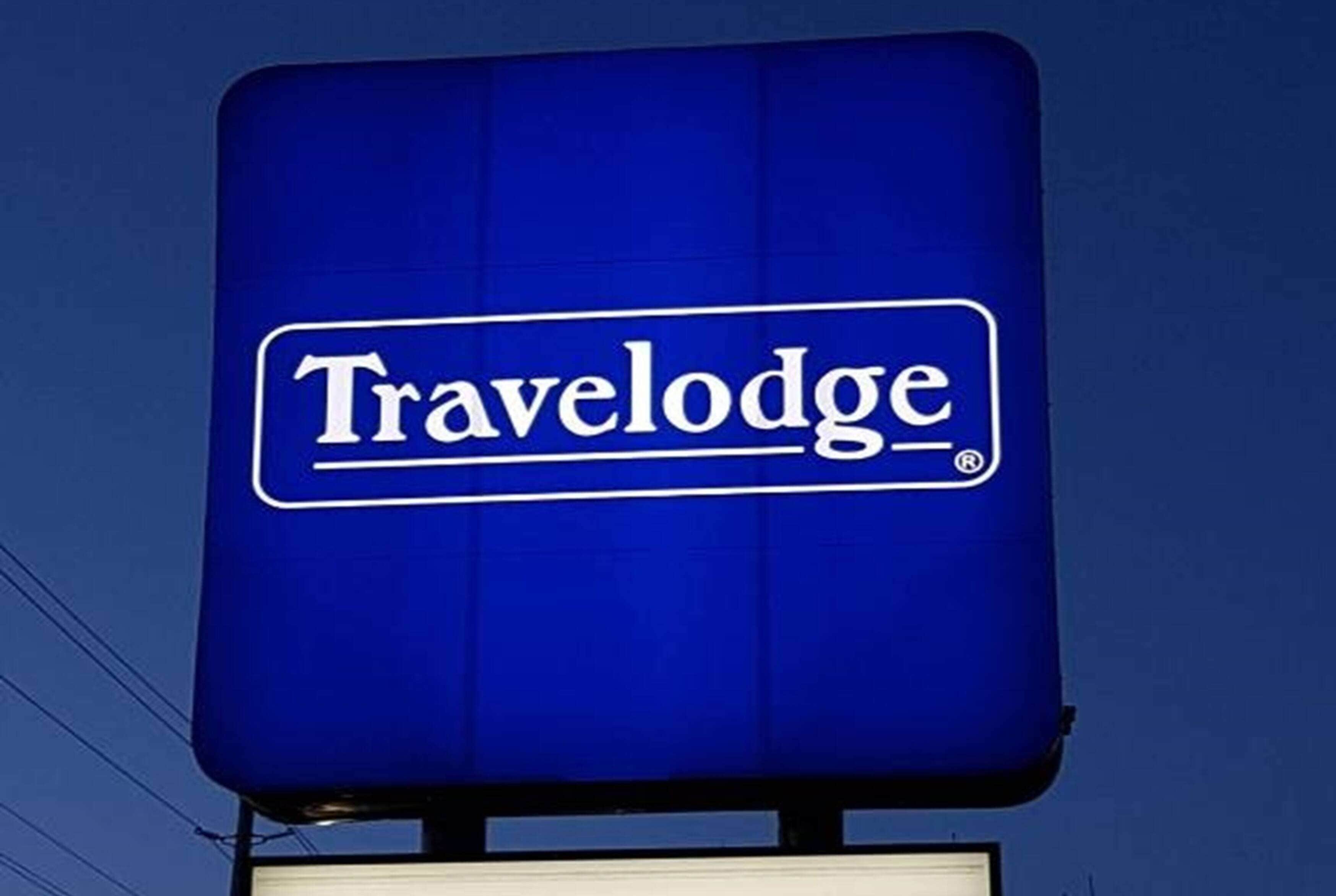 A blue sign with the word "Travelodge" and a registered trademark symbol.
