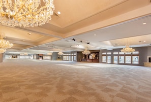 Experience the grandeur of this spacious interior with a high ceiling, elegant chandeliers, and large windows offering stunning views.