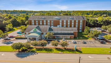 A Marriott Express hotel with a central courtyard, parking lot, and surrounding greenery.