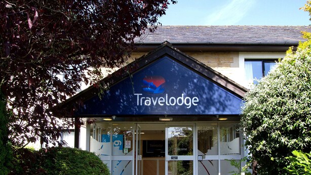 A Travelodge building with a dark blue awning and a sign above the entrance. - Travelodge Burton M6 Northbound (Carnforth)
