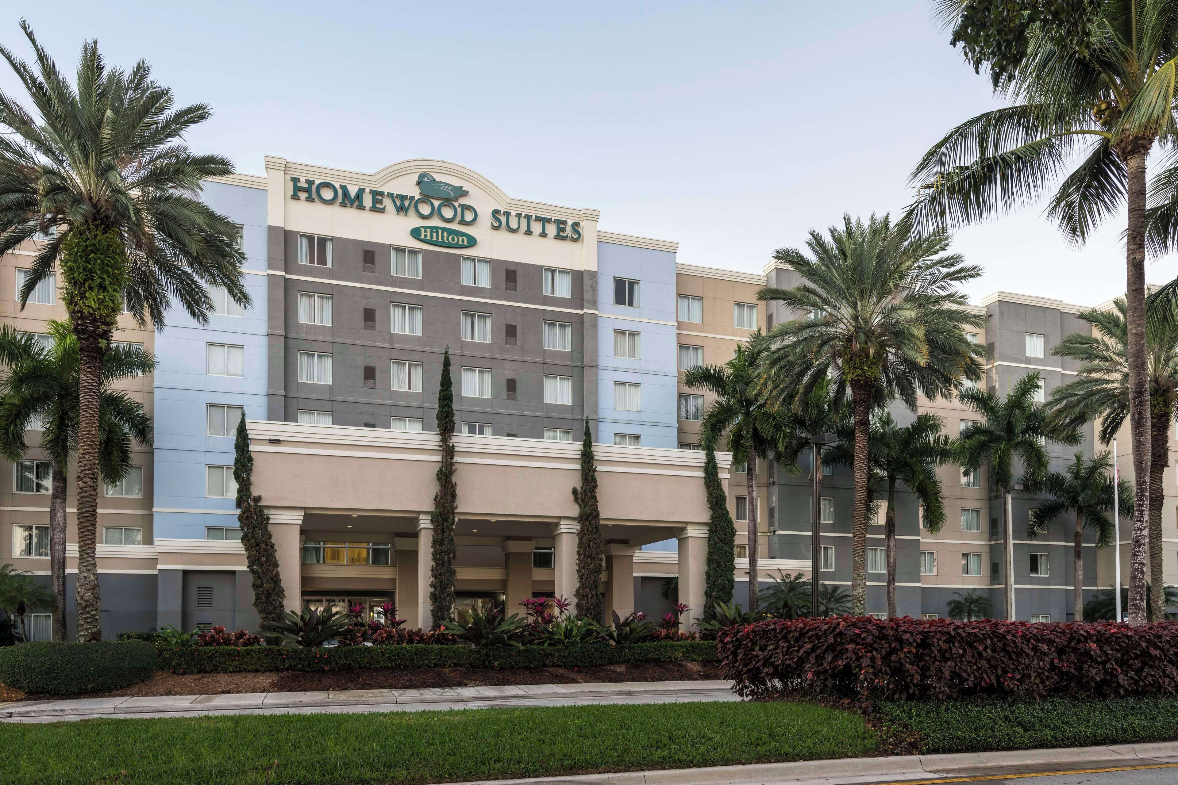 A multi-story hotel with a sign reading "Homewood Suites Hilton."