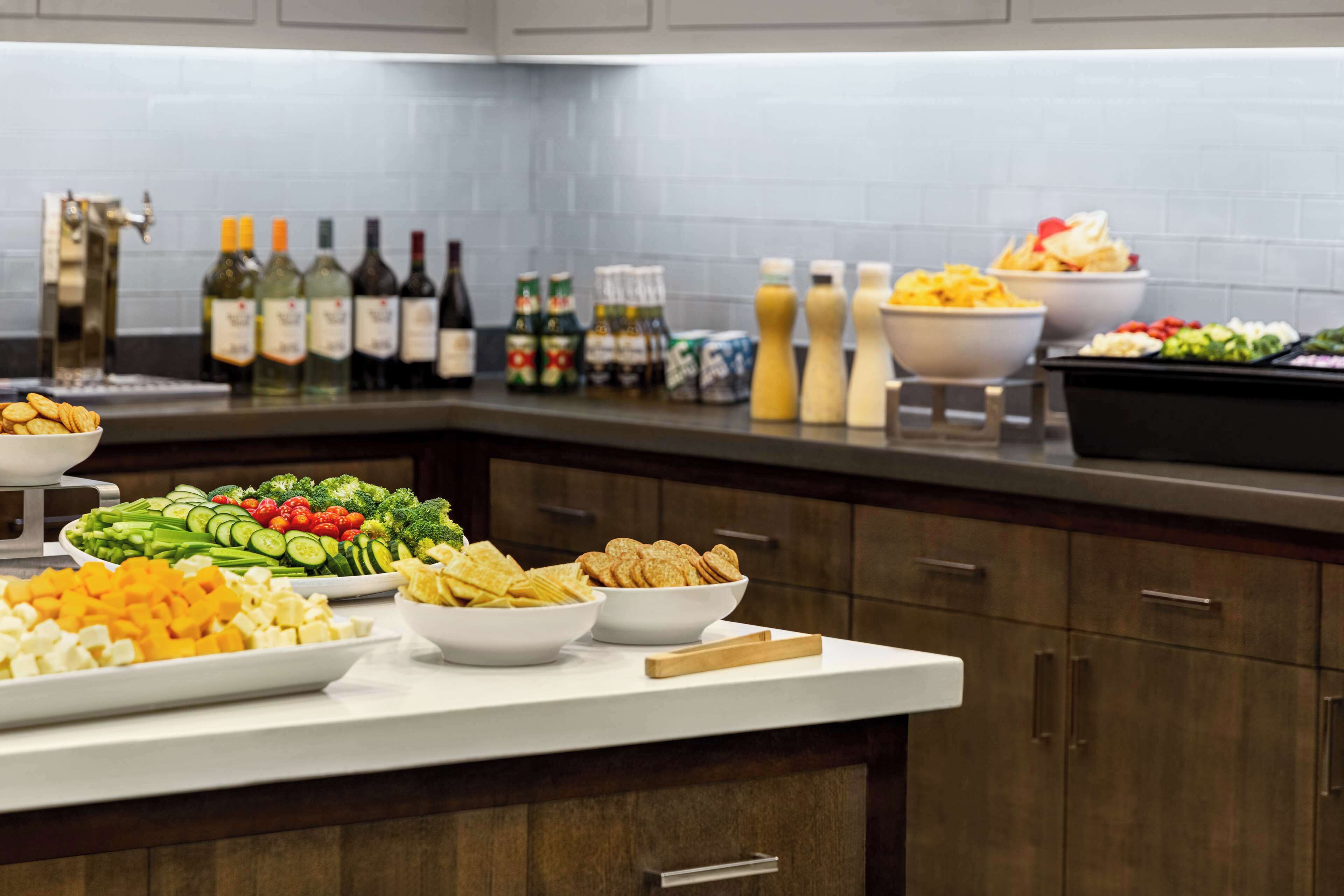 A buffet setup with various food items and beverages.