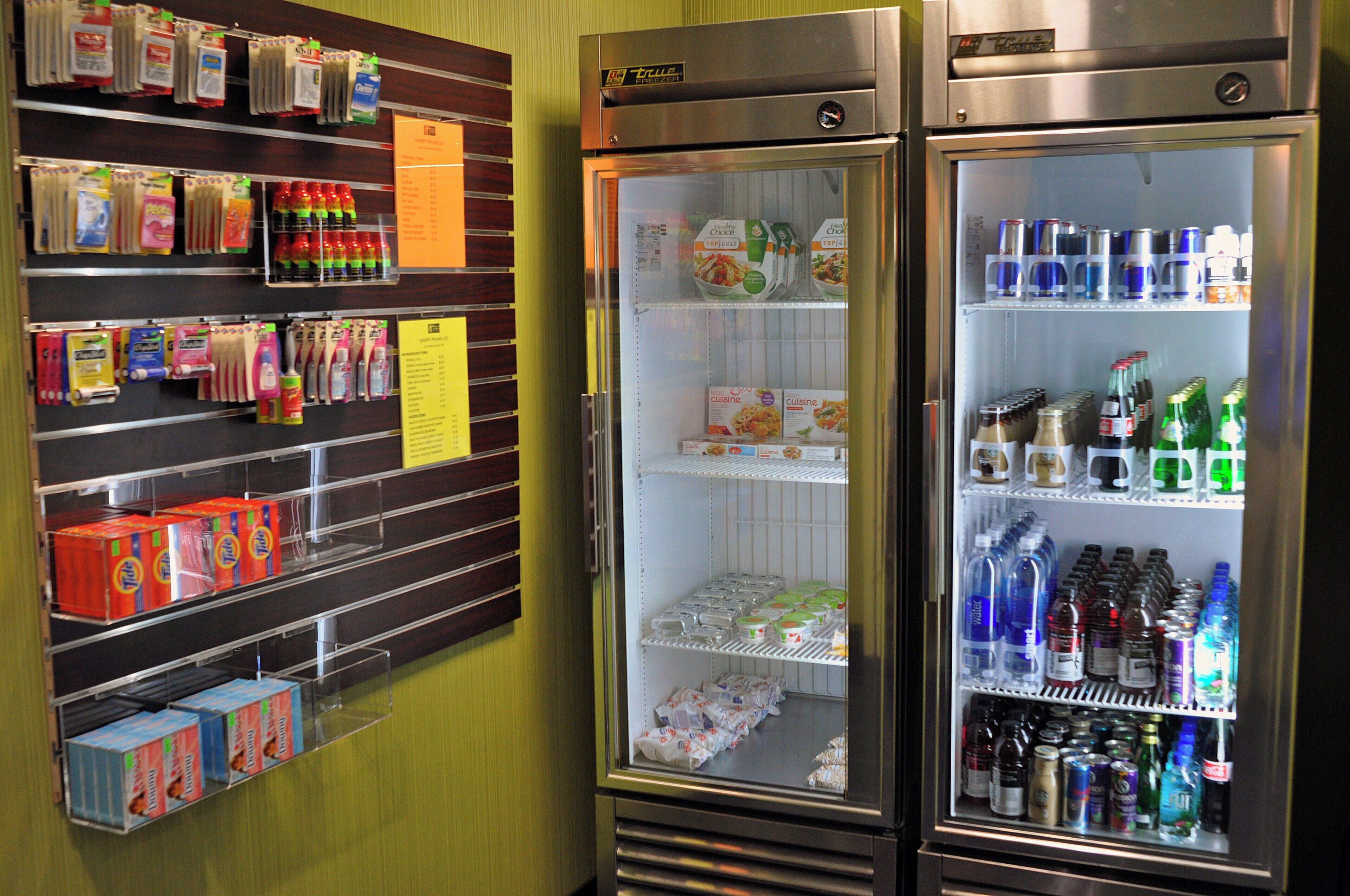 A refrigerated display with various beverages and packaged goods.