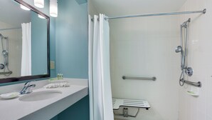 A modern bathroom with a sink, mirror, and shower. - Holiday Inn Express Suites Plant City by IHG (Plant City)