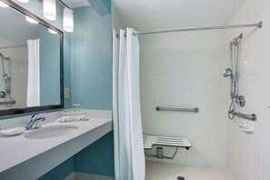 A modern bathroom with a sink, mirror, and shower. - Holiday Inn Express Suites Plant City by IHG (Plant City)