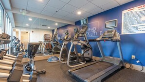 A gym with treadmills, elliptical machines, and weight benches. - Holiday Inn Express Hotels & Suites Cocoa Beach by IHG (Cocoa Beach)