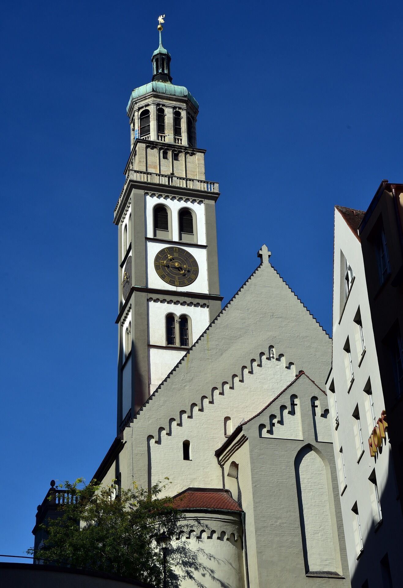A church with a prominent clock tower and a pointed roof.
