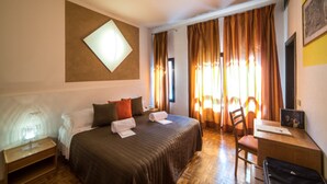 A hotel room with a bed, a desk, a chair, and a window with curtains. - Hotel La Vecchia Cartiera (Colle di Val d'Elsa)