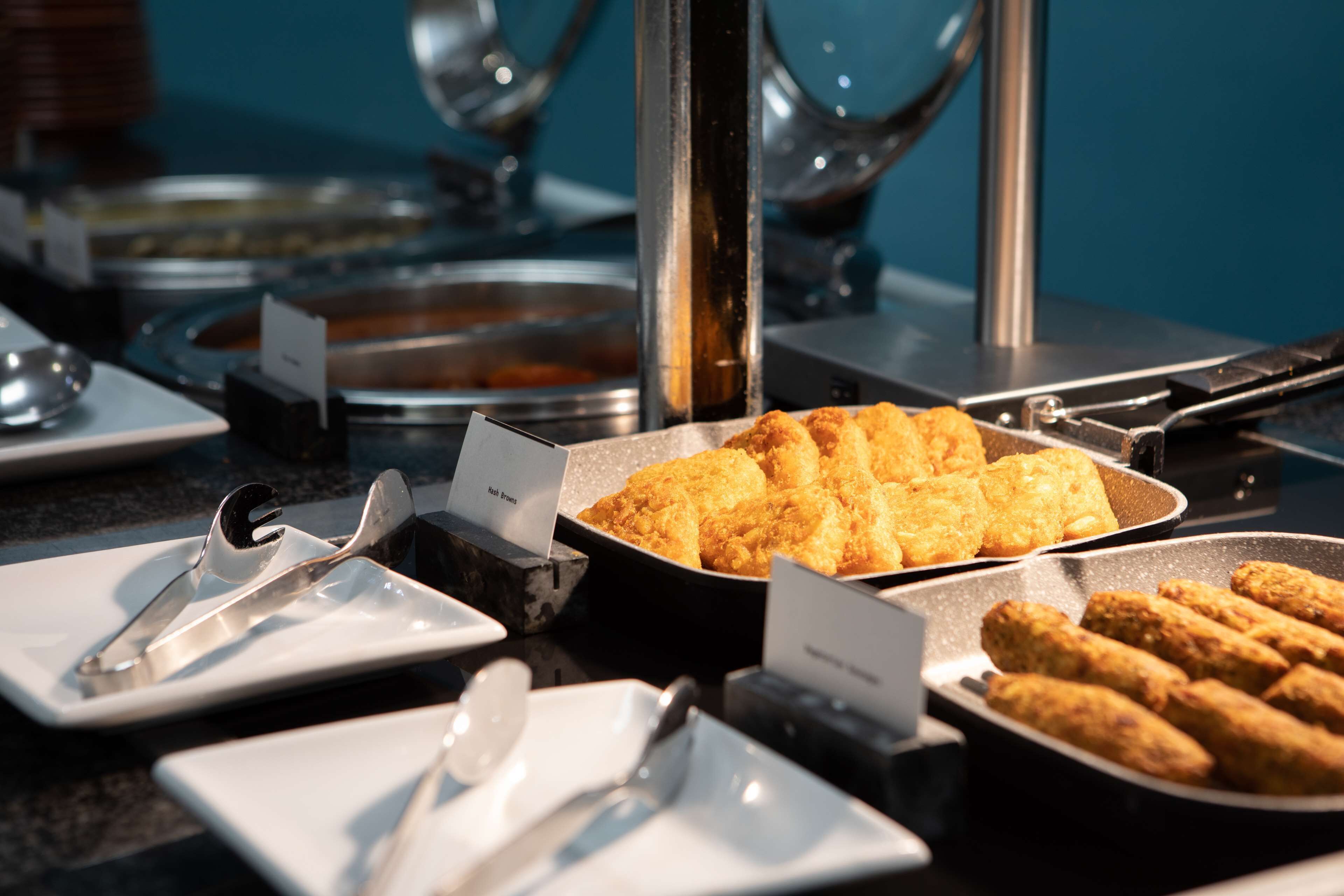 A buffet with various dishes, including fried items and a pan of what appears to be a casserole.