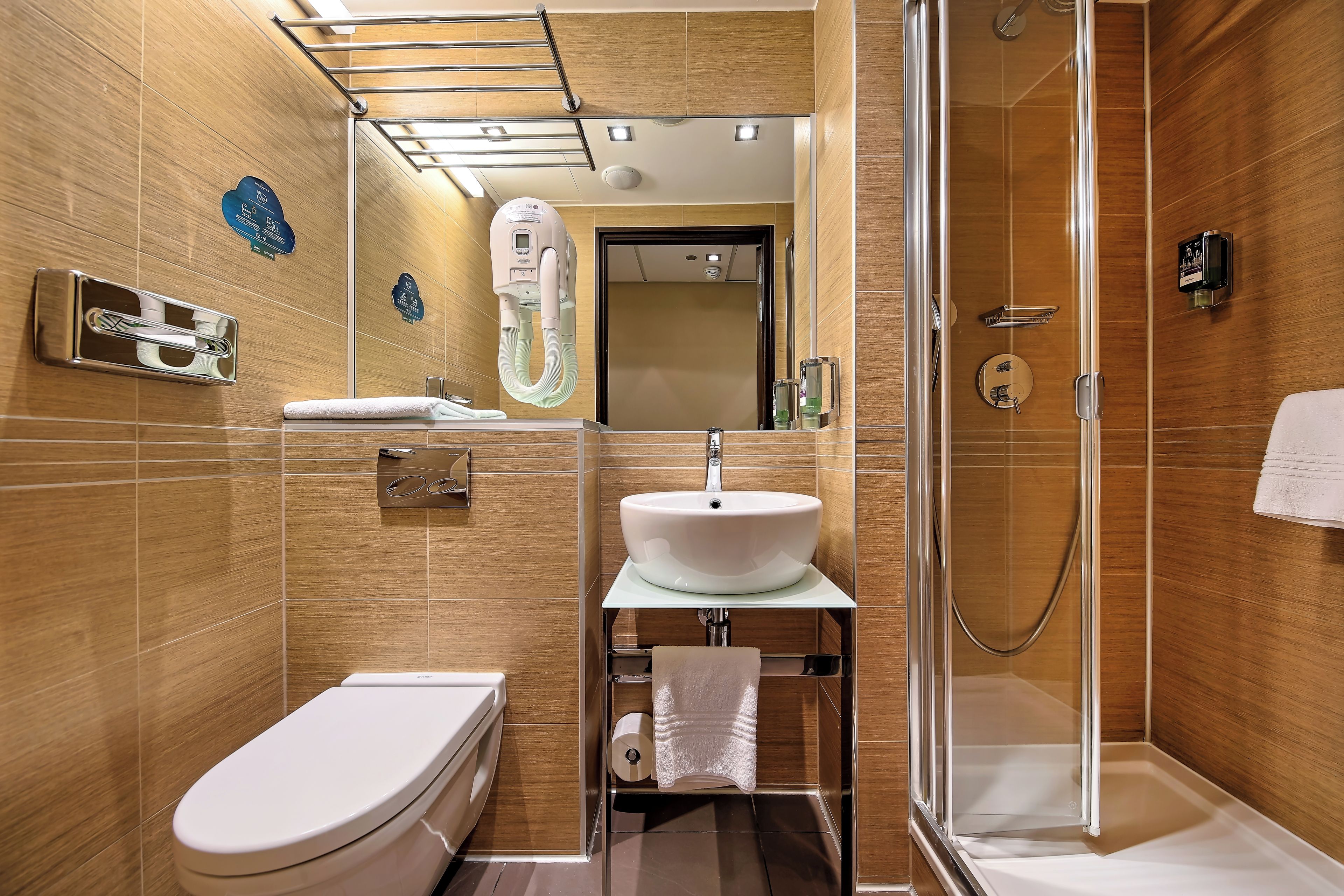 Une salle de bain moderne équipée de toilettes, d’un lavabo et d’une douche.