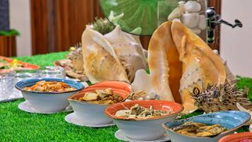 A table with various dishes and decorative shells.