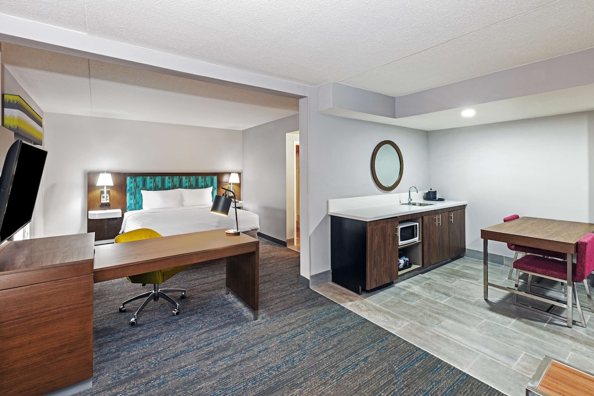 suite, 1 king bed, non smoking | in-room safe, desk, iron/ironing board, free cots/infant beds