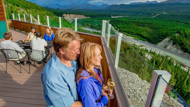 A deck with outdoor seating overlooking a scenic landscape. - Grande Denali Lodge (Denali National Park)