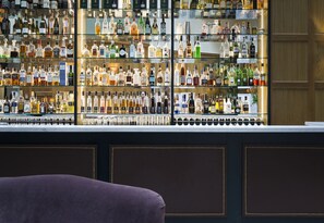 A bar area with multiple shelves of various liquor bottles. - Hotel Kung Carl, WorldHotels Crafted (Stockholm)