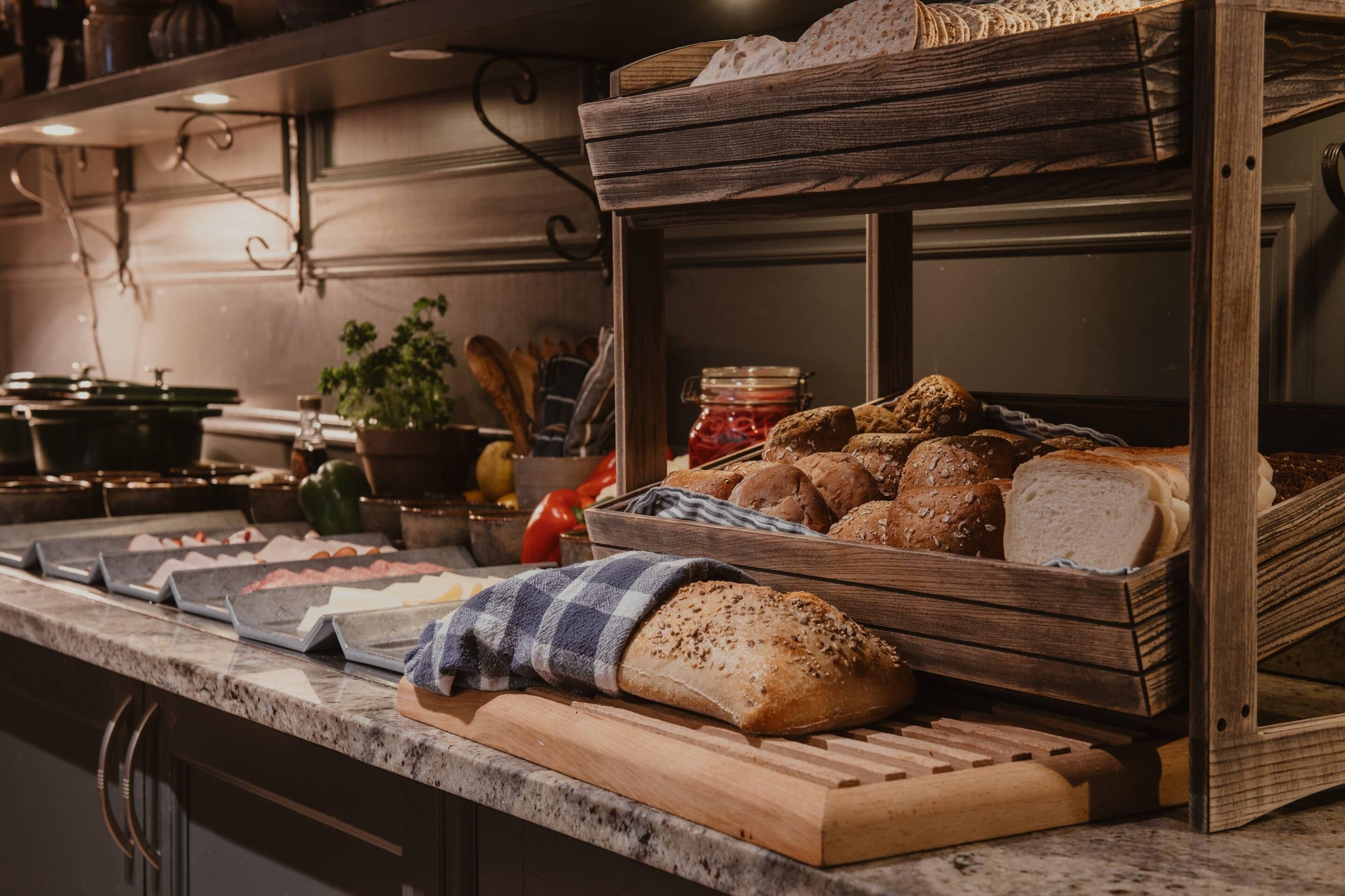 A bakery display with various breads and pastries.