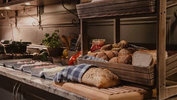 A bakery display with various breads and pastries.