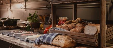 A bakery display with various breads and pastries.