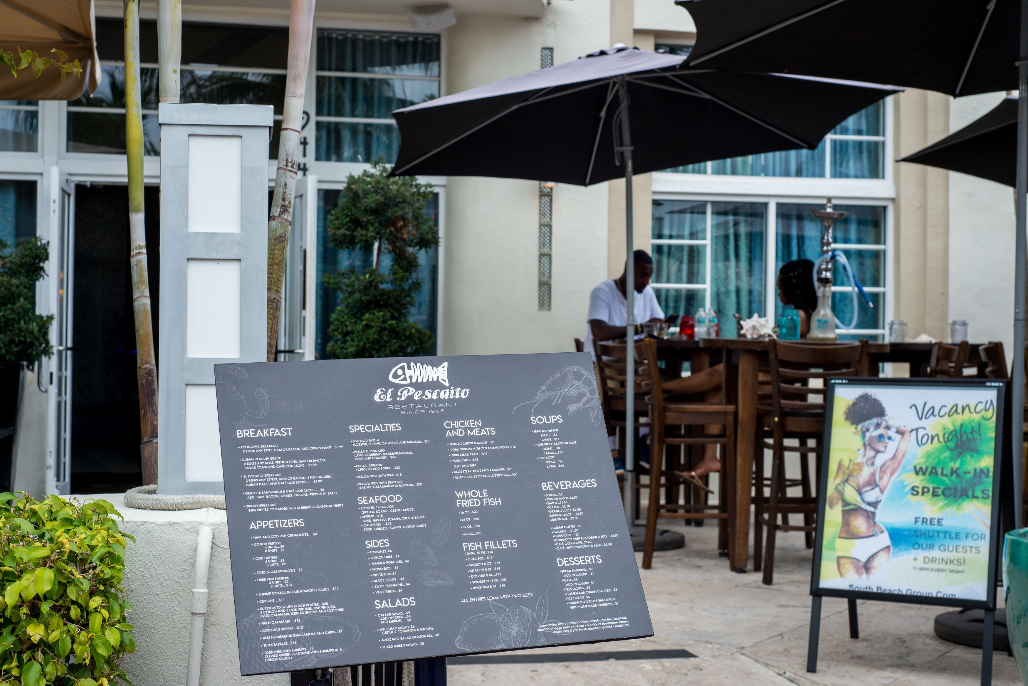 A restaurant menu board with various food categories.