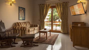 Family Suite, 1 King Bed with Sofa bed, Garden View | Living room | LED TV, toys