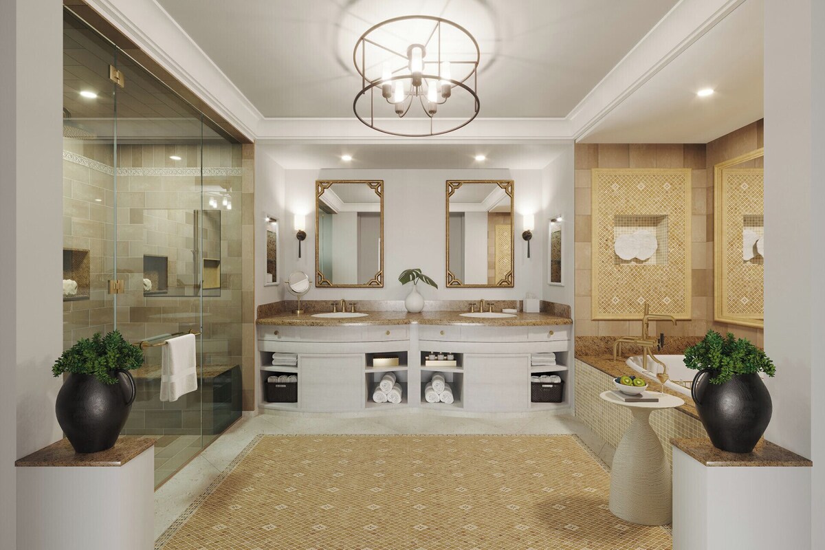 A modern bathroom with a double sink vanity, large mirrors, a glass shower enclosure, and decorative plants.