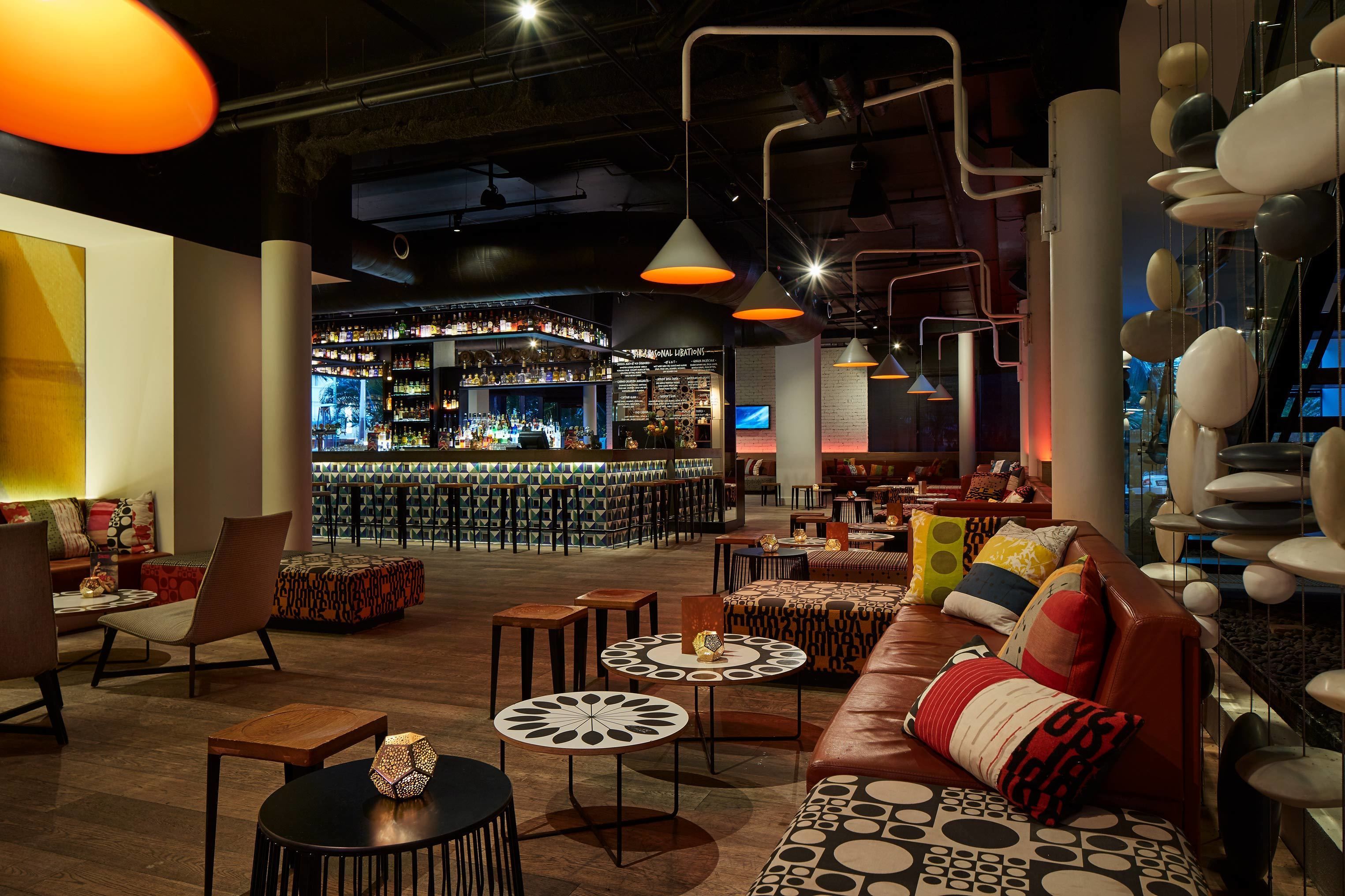 A modern bar area with seating and a bar counter.