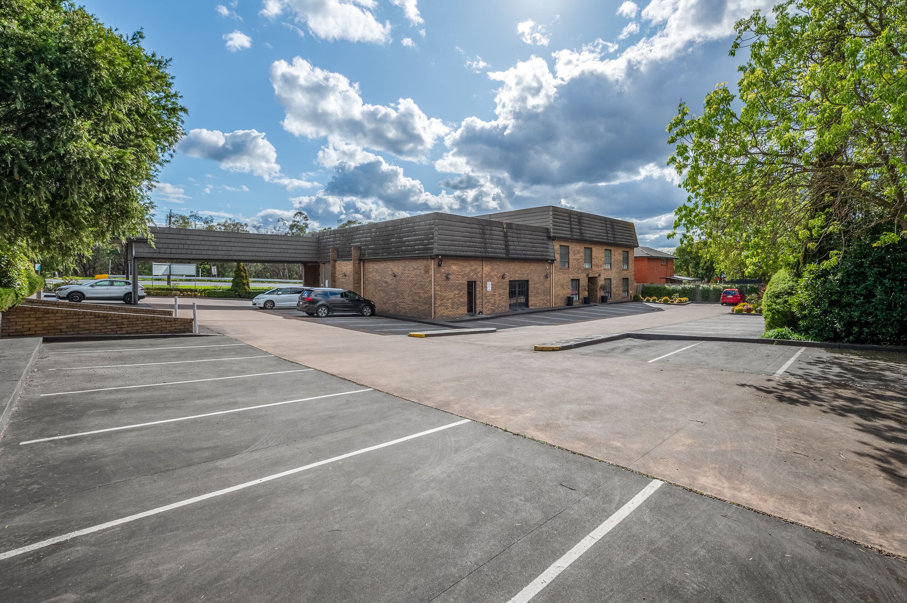 A parking lot with a building in the background.